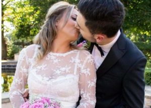 bride wearing A LACE BRIDAL TOP AND KISSING GROOM