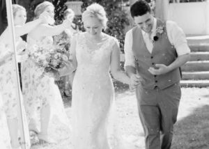 black and white photo of a bride and groom walking together